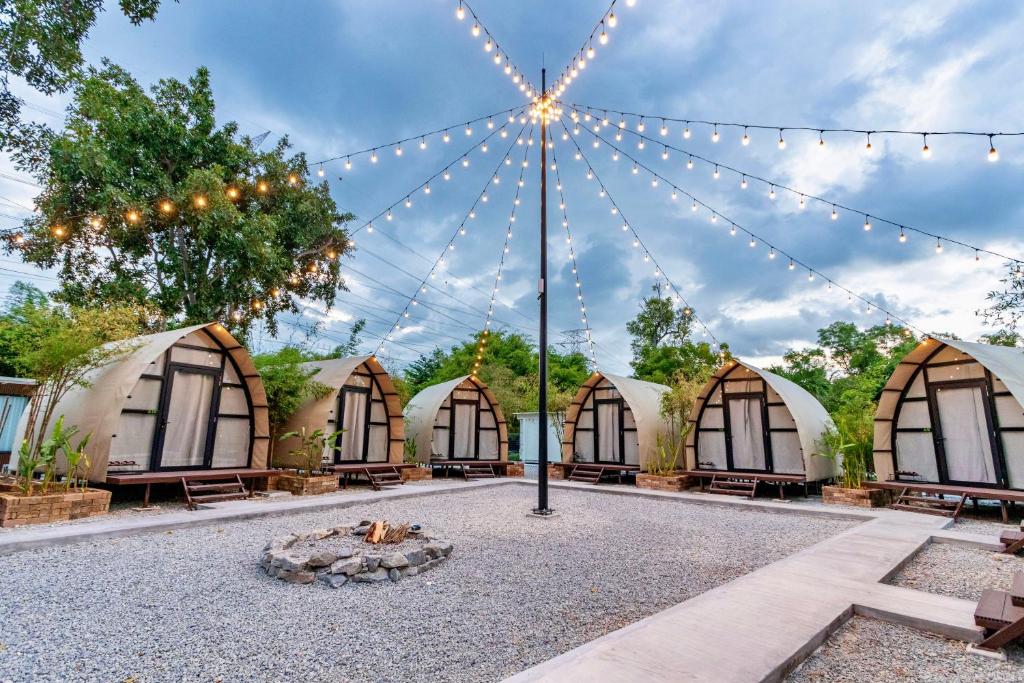 a courtyard with domes and a fire pit with lights at Nadi Glamping Suites, Auto-City in Perai