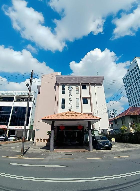 a building on the side of a street with a car at Palace Inn in Miri
