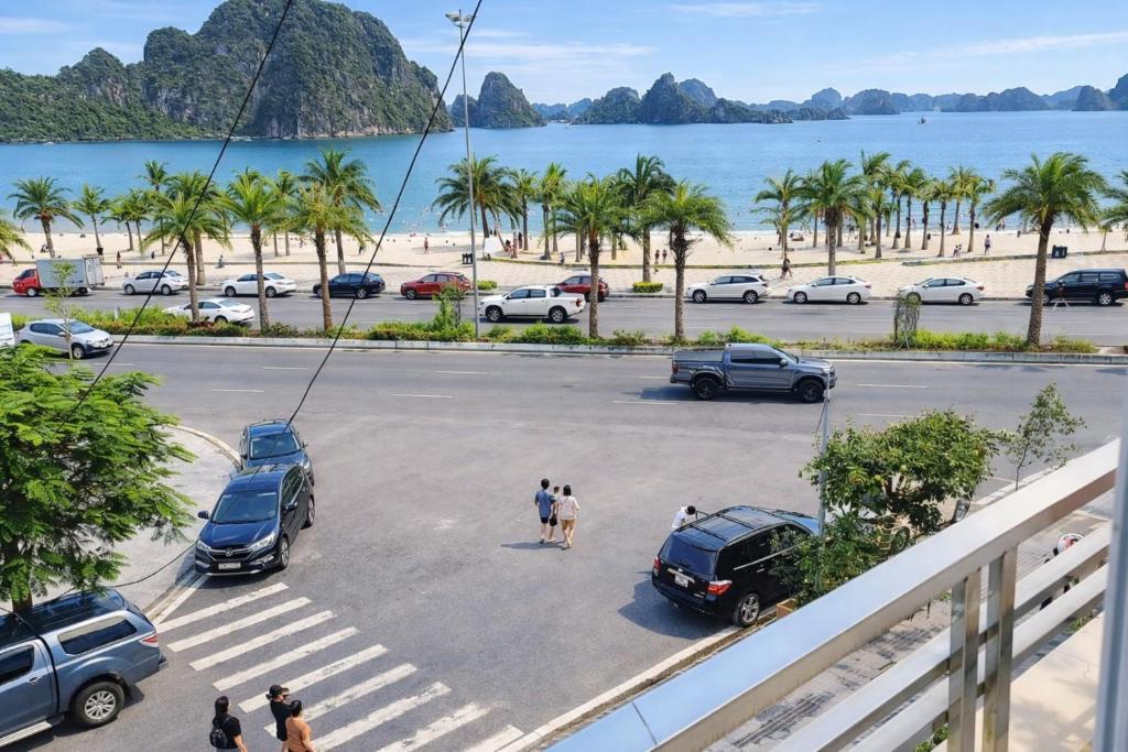 a parking lot next to a beach with cars parked at Sao Mai Hotel Hạ Long in Ha Long