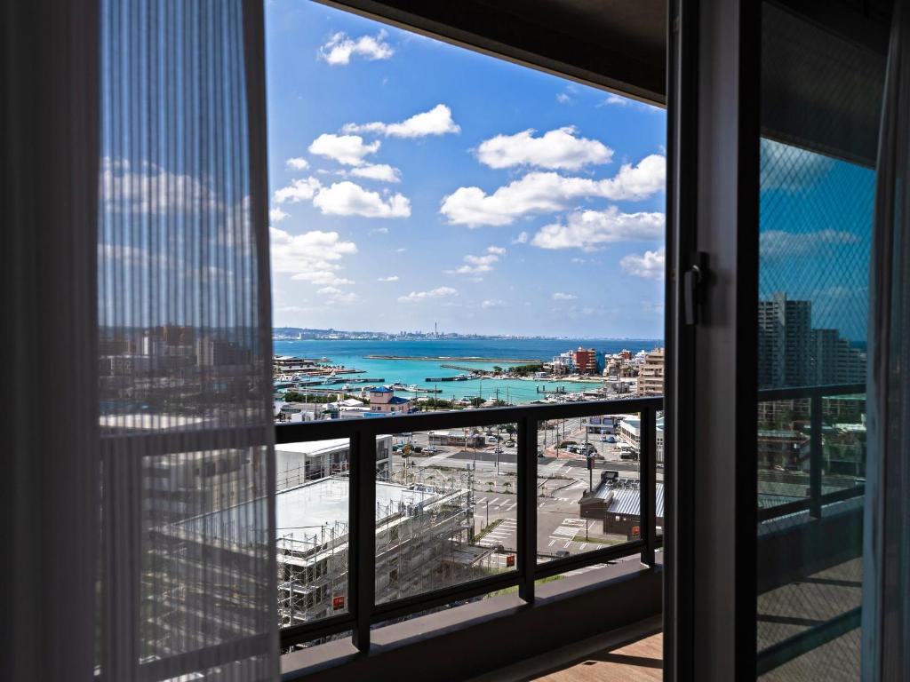 a window view of the ocean from a skyscraper at The Hotel Chatan by Sunrest Resort in Chatan