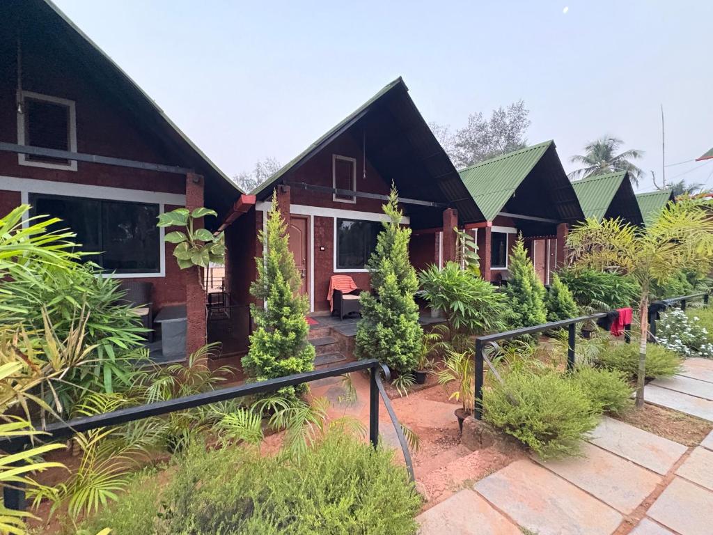 a house with a garden in front of it at Taya Beach Front in Gokarna