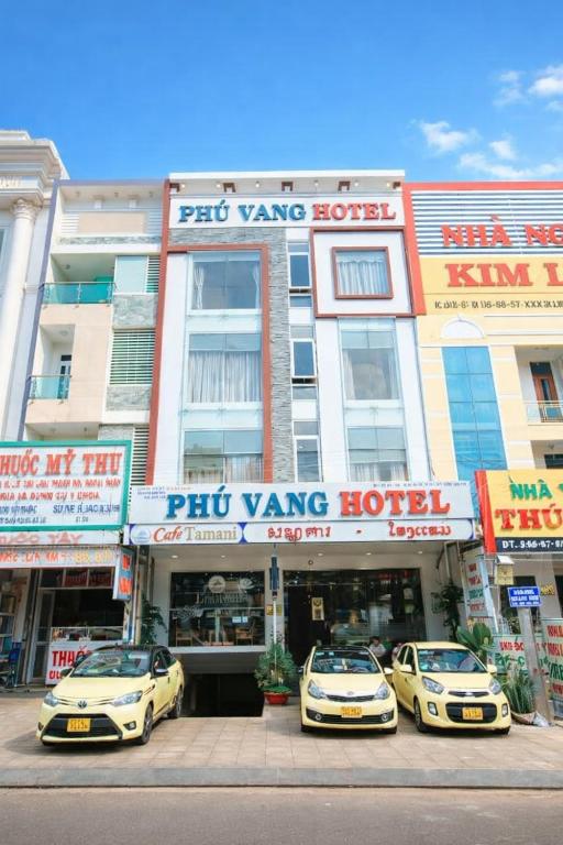 three cars parked in front of a hotel at Phú Vang Hotel Pleiku in Pleiku