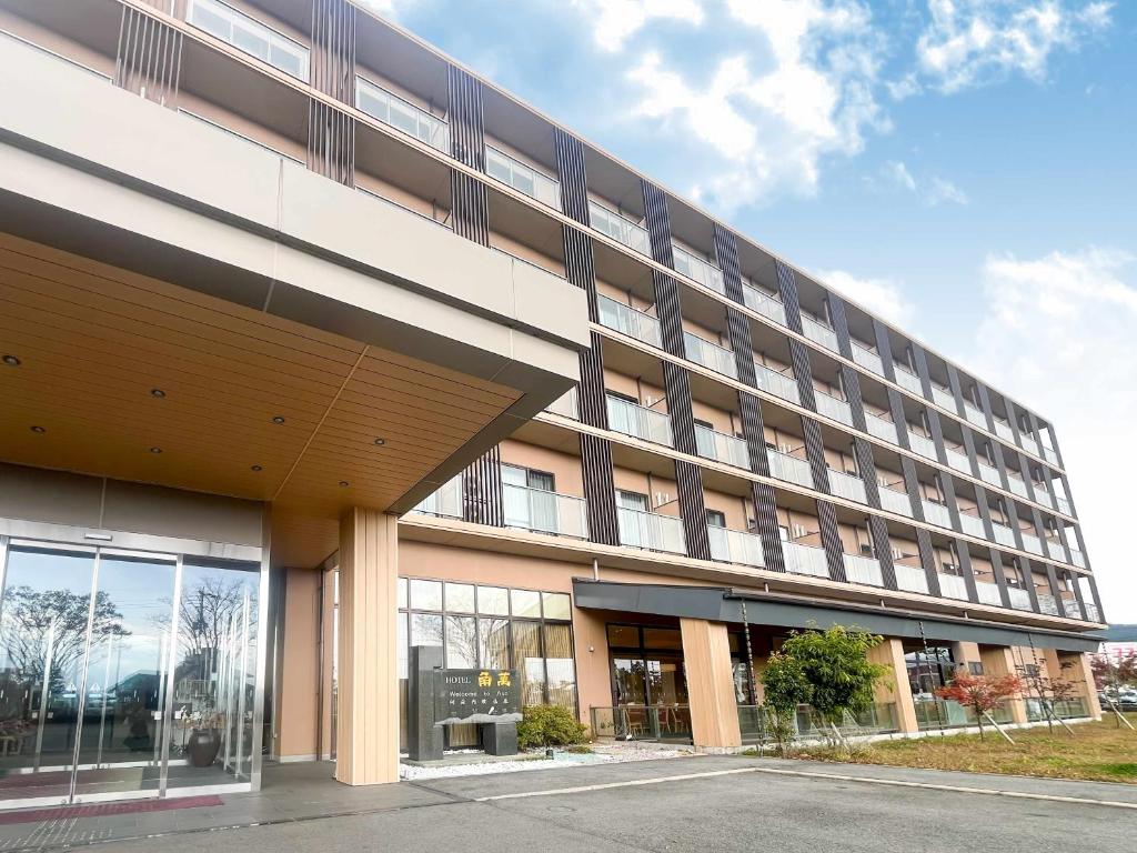 a large building with a lot of windows at Hotel Kadoman in Aso