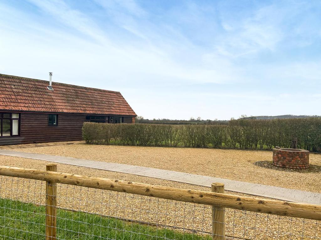 a wooden fence in front of a house at Hog Pits - 18961 in Tytherton Lucas