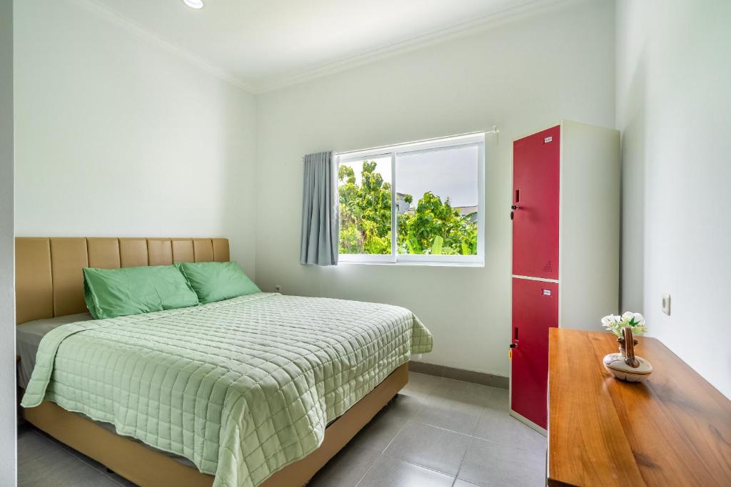 a bedroom with a bed and a window at The Twenty Eight in Ungasan
