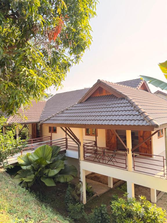 a house with a pitched roof at Baan Yanikar in Lampang