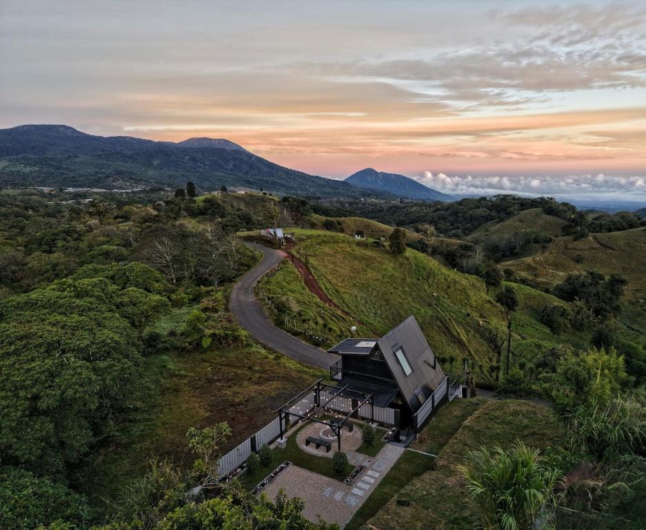 an aerial view of a house on a hill with a road at Luxury AFrame with Private Jacuzzi Poás Volcano in Vara Blanca