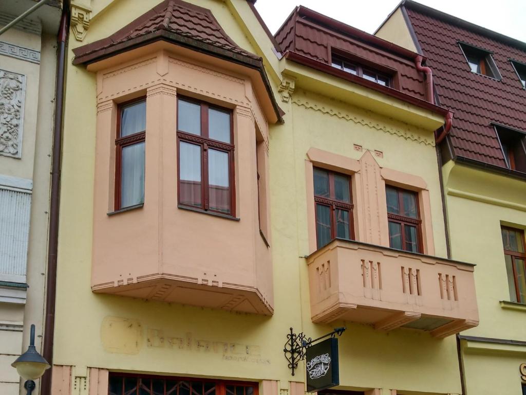 a yellow building with windows and a roof at Apartment Downtown in Žilina