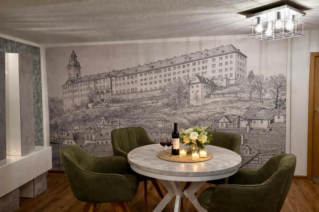 a dining room with a table with a drawing on the wall at AltstadtQuartier Rudolstadt Ankommen l Bleiben in Rudolstadt