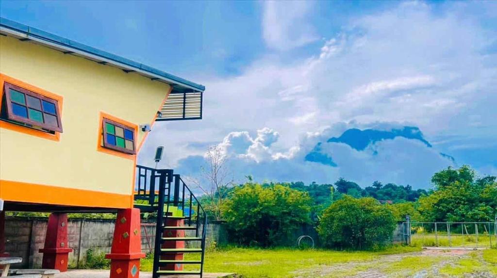 a house with a staircase leading up to it at Thung Setthi Homestay&Cafe4 in Chiang Dao