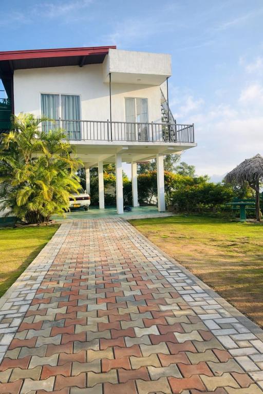 a house with a brick walkway in front of it at Bloom house homestay in Bandarawela