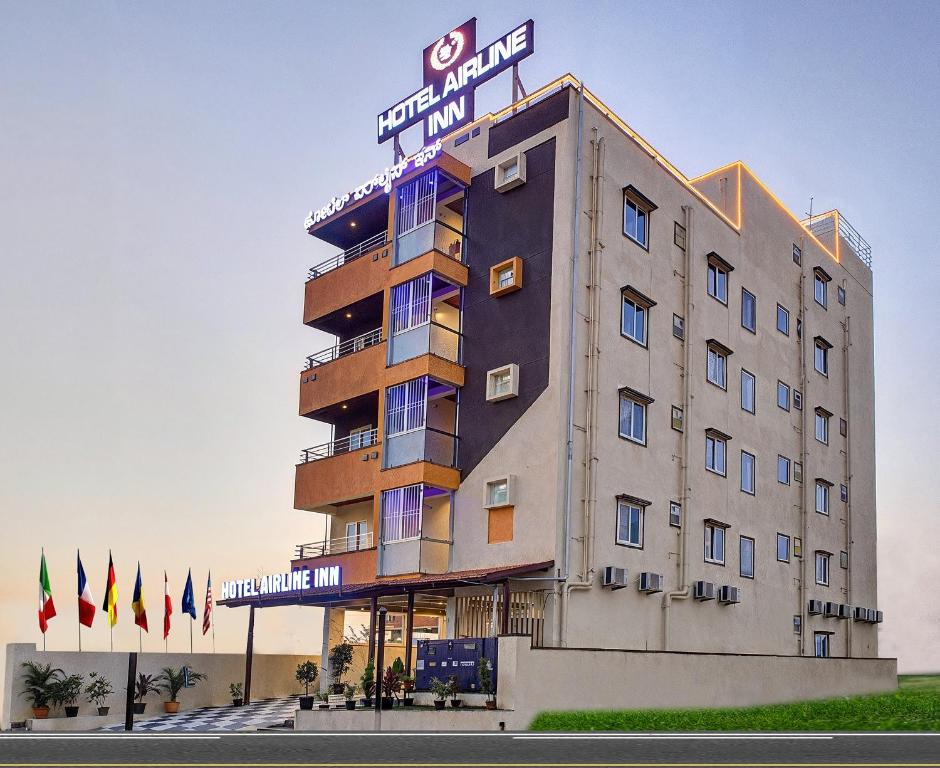 a hotel building with a sign on top of it at Hotel Airline Inn - Near Kempegowda International Airport in Muthugadahalli
