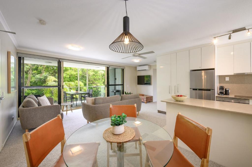 a kitchen and living room with a table and chairs at #2 Hastings Street in Noosa Heads