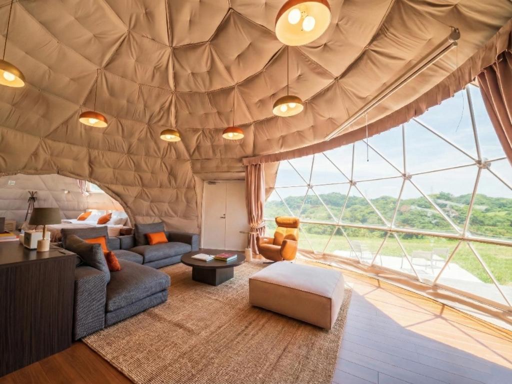 a living room in a tent with a large window at GLAMPROOK Futtsu BRISTOL HILL in Futtsu