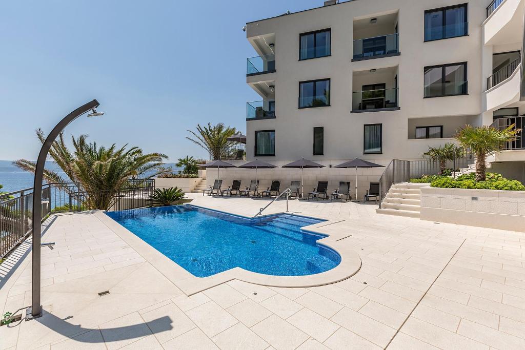 a swimming pool in front of a building at Villa Sky in Mimice