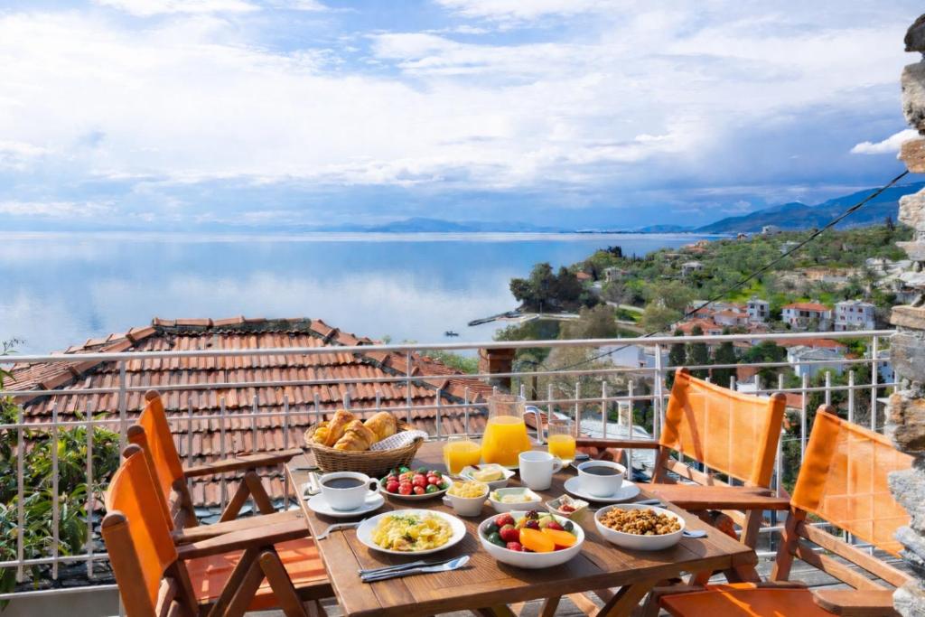 a table with food and a view of the water at Vista Mare in Afissos