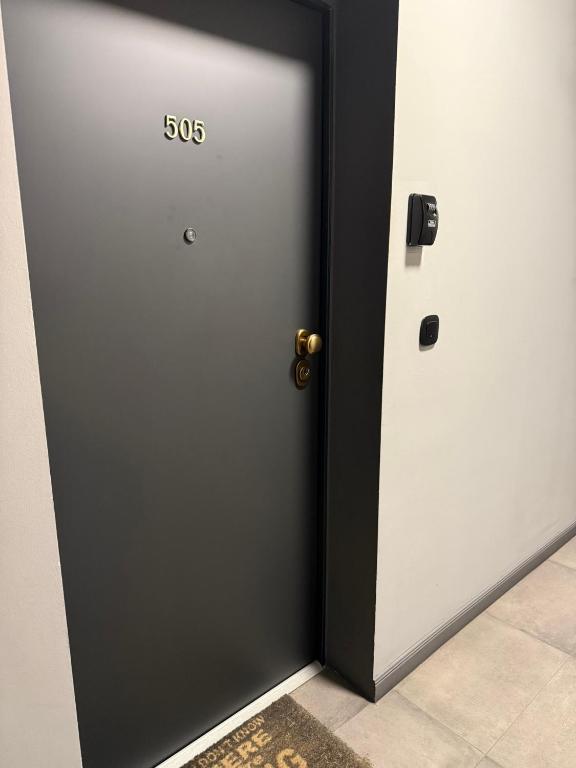 a door with the on it in a room at Stylish city centre apartments in Budapest
