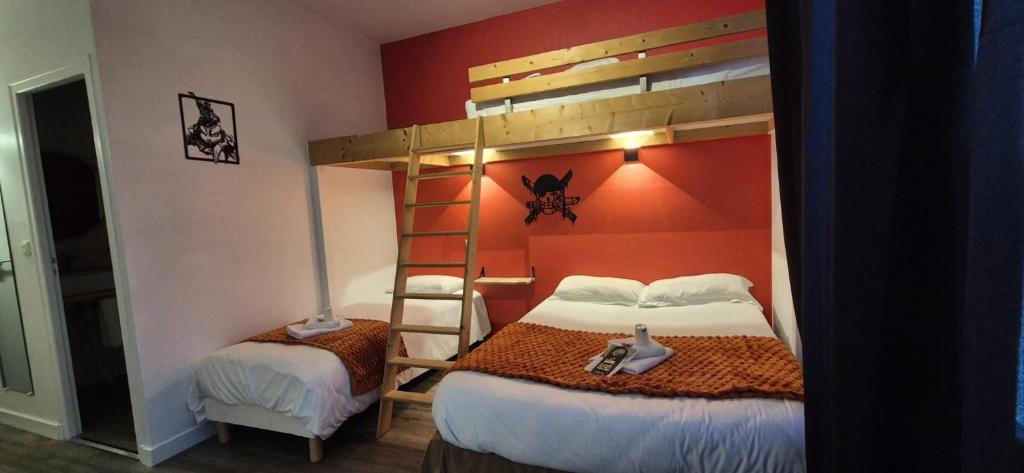 a bedroom with two bunk beds and a ladder at Domaine du Bocage in Chavagnes-en-Paillers