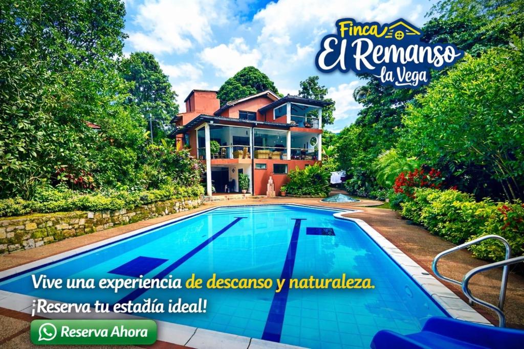 a house with a swimming pool in front of it at Finca El Remanso La Vega in La Vega