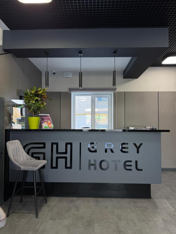 an office with a counter with a chair and a desk at Grey Hotel in Oral