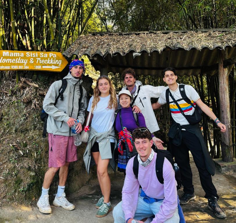a group of people posing for a picture in front of a hut at Sisi House Experience Hike & Batik Painting in Sa Pả