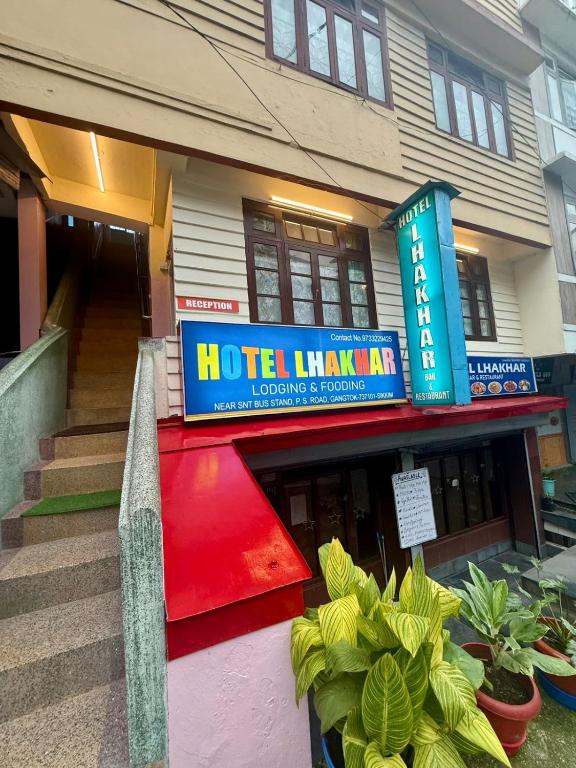 a hotel hawaiian sign in front of a building at Hotel Lhakhar in Gangtok