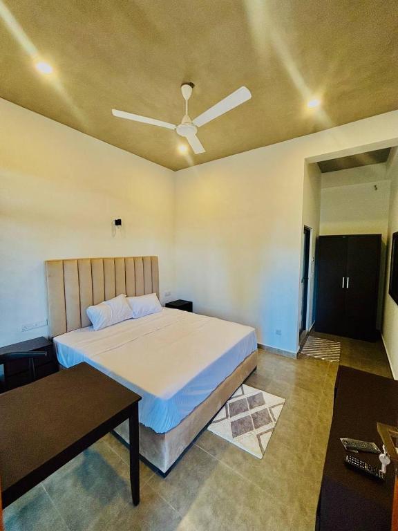 a bedroom with a bed and a ceiling fan at Ceylan Dream Hiriketiya in Nilwella