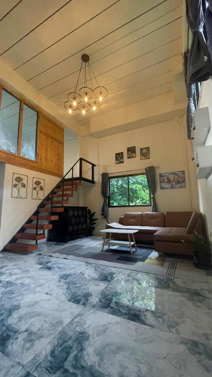 a living room with a large pool in the middle at Sunray Hill in Ranong