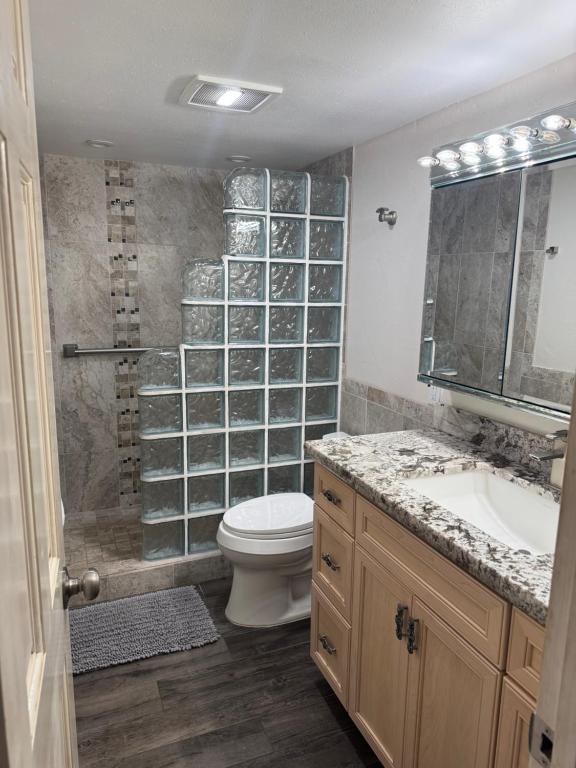 a bathroom with a toilet and a sink and a shower at The Happy Hideaway - Maui Calm by the Ocean in Kihei