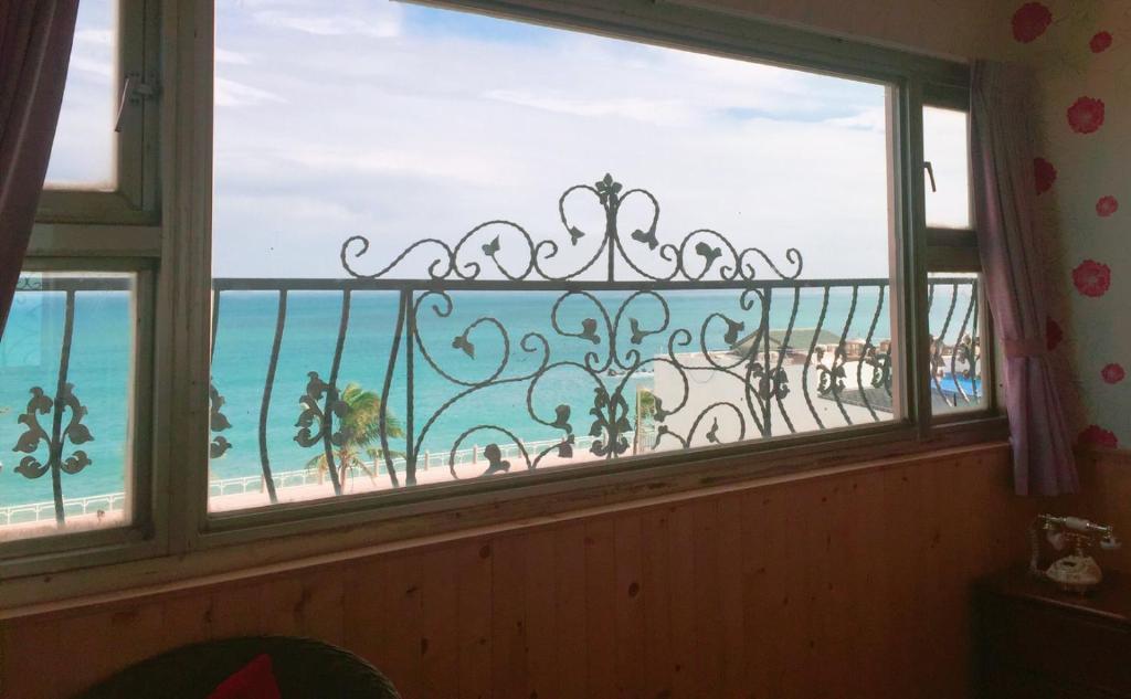 a window with a view of a beach and the ocean at Constellation Coast B&B in Hualien City