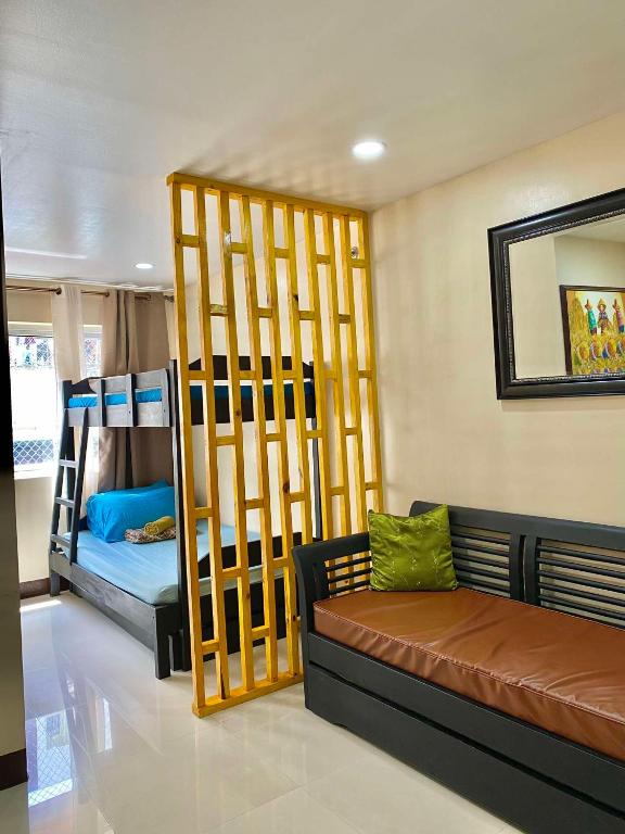 a room with two bunk beds and a couch at LG-15B City Center Staycation at Megatower 1 in Baguio