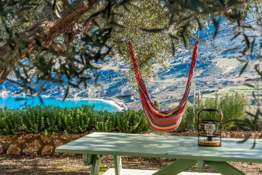 a hammock hanging from a tree over a picnic table at Villa lito in Zóla