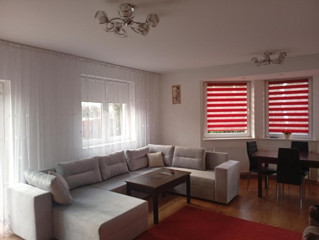 a living room with a couch and a table at Dom na Konwaliowej in Narew