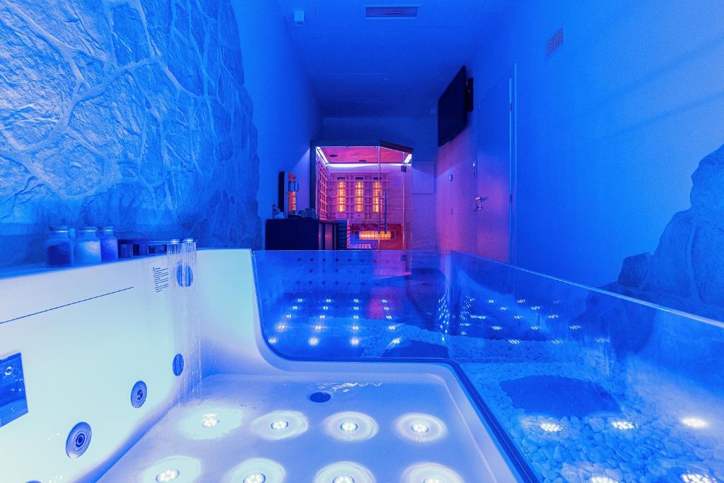 a bathroom with a bath tub with blue lights at Antica Corte Lugo in Lugo