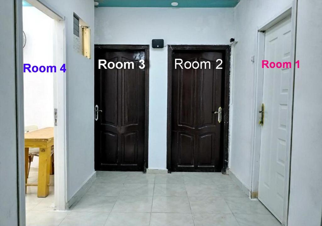 two doors in a room with names on them at room 3 a room in Hostel of 4 rooms in Hurghada