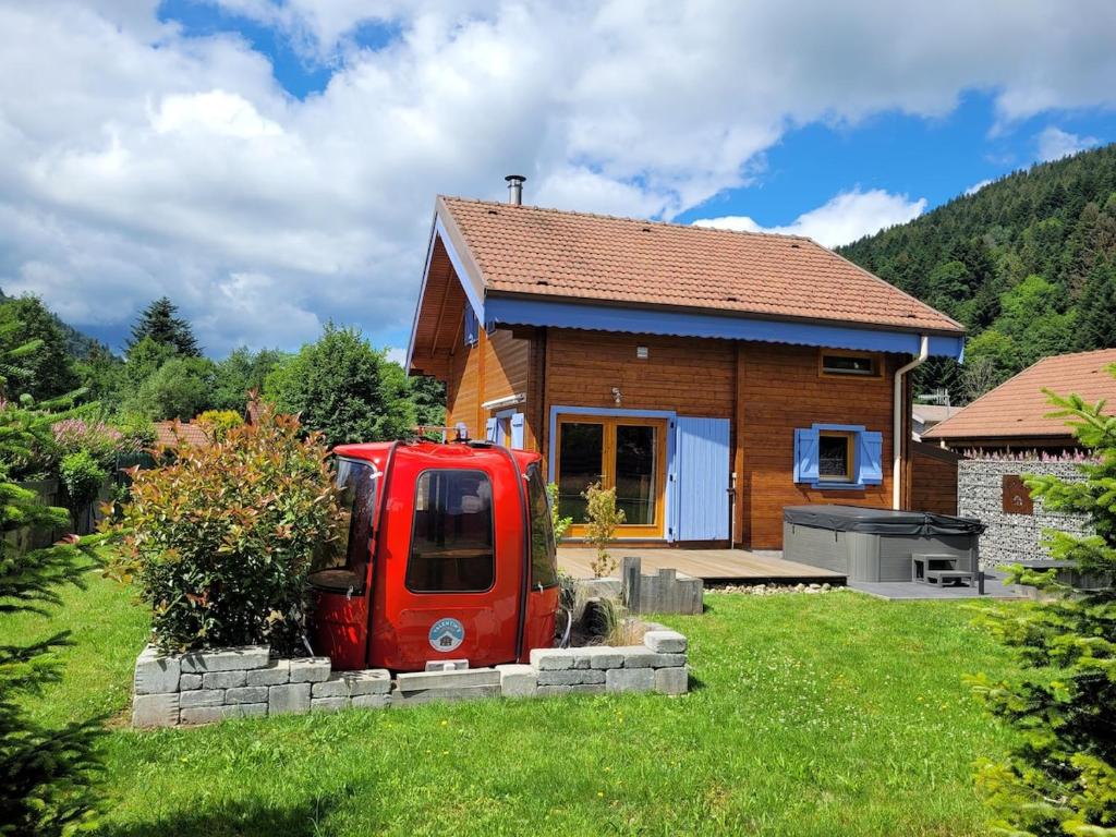 a red van parked in front of a house at Chalet Cocoon 6p avec Spa privé in Rochesson
