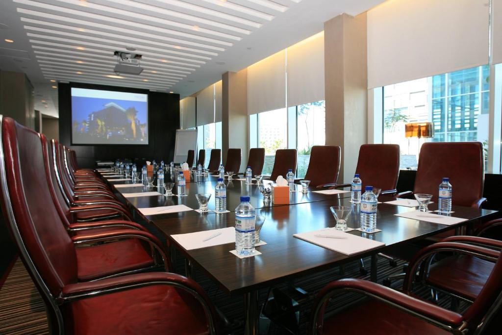 a large conference room with a long table and chairs at Yas Plaza Circuit by IHG in Abu Dhabi
