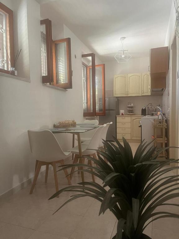 a kitchen and dining room with a table and chairs at House Federica in Melfi