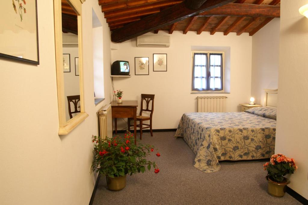 Postel nebo postele na pokoji v ubytování Hotel Calzaiolo