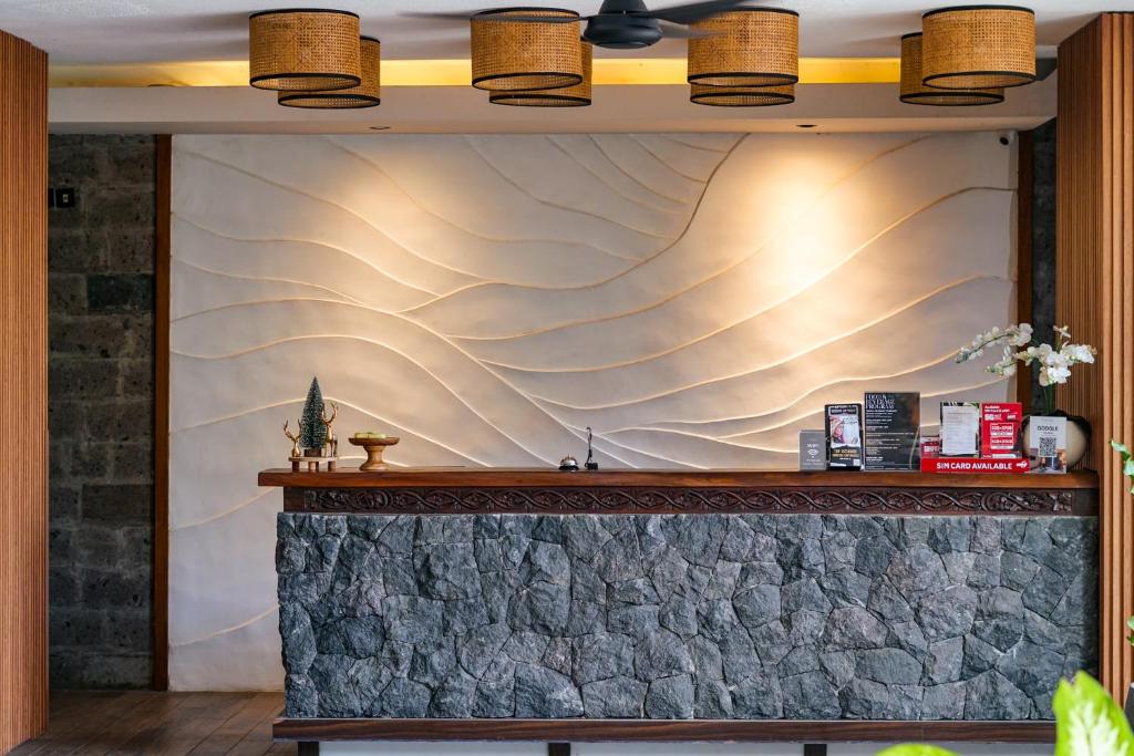 a wall mural in a restaurant with a counter at Tusita Boutique Hotel in Kuta
