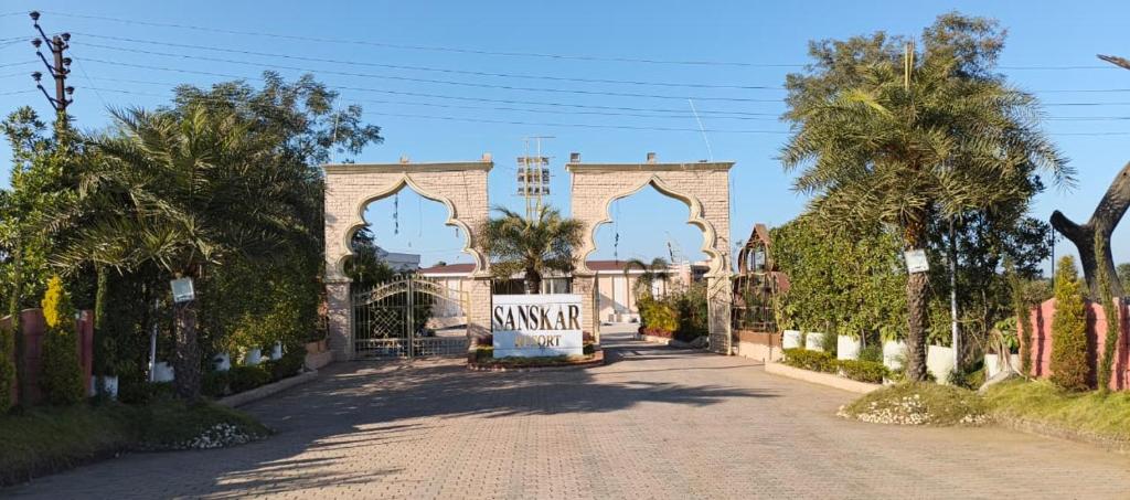 a building with a gate on a street at Sanskar Resort in Pānāgar