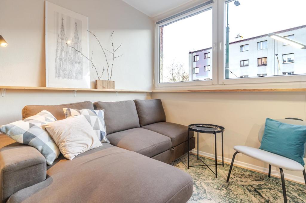 a living room with a couch and a chair at Sosnowiec Downtown Studio by BookingHost in Sosnowiec
