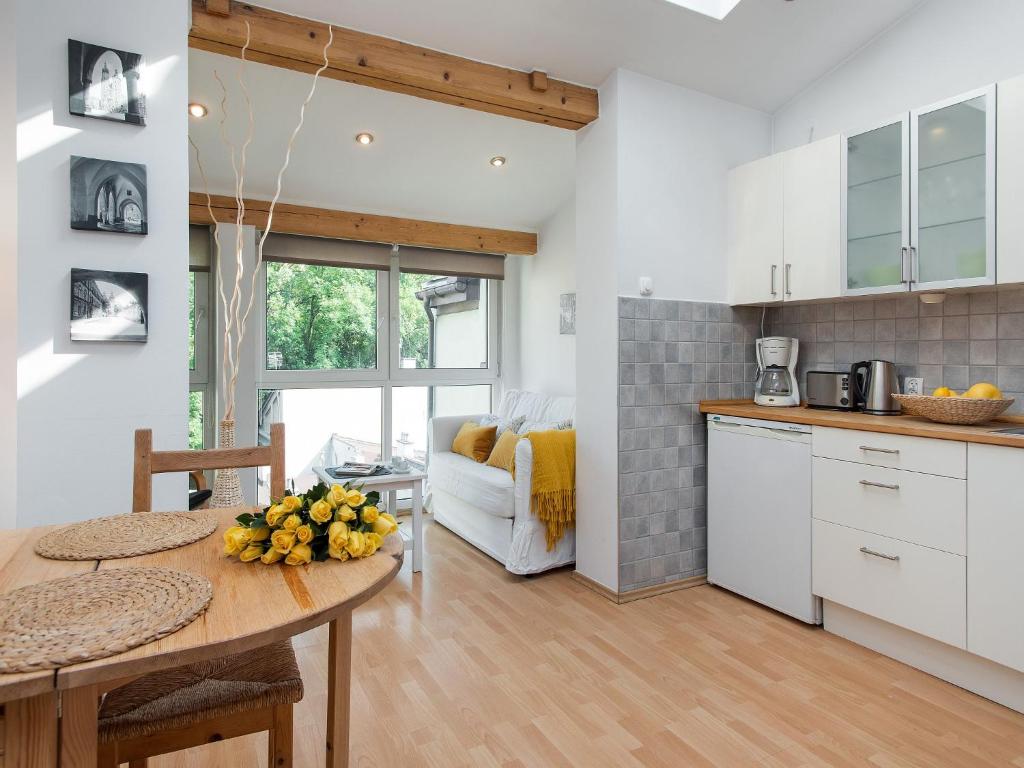 a kitchen with a table with a bowl of fruit on it at Studio Smart Apartment in Krakow