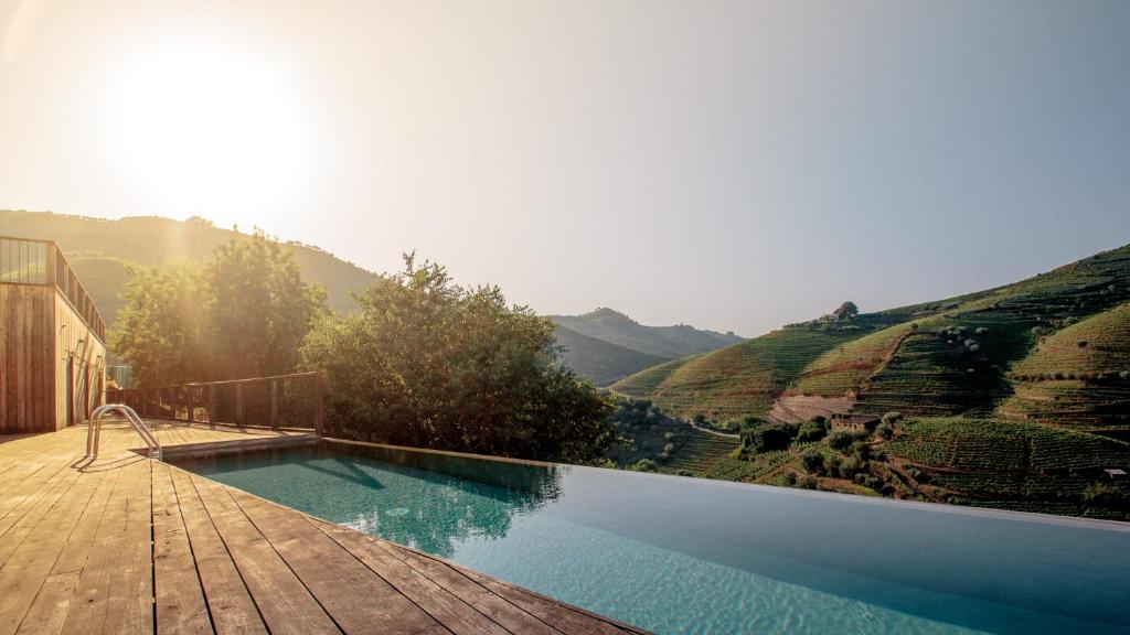 a swimming pool with a view of a mountain at Quinta do Vale da Ermida, Private - Heated - Pool in Ermida