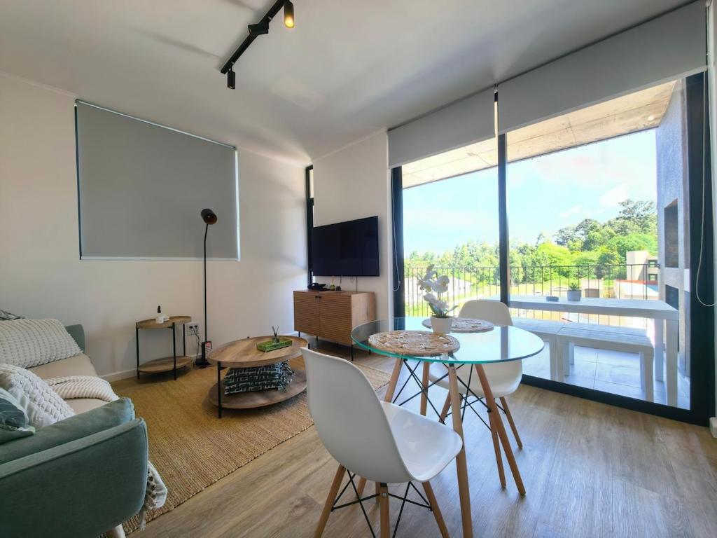 a living room with a couch and a table and chairs at Luxury Apartment Unit 101 in George