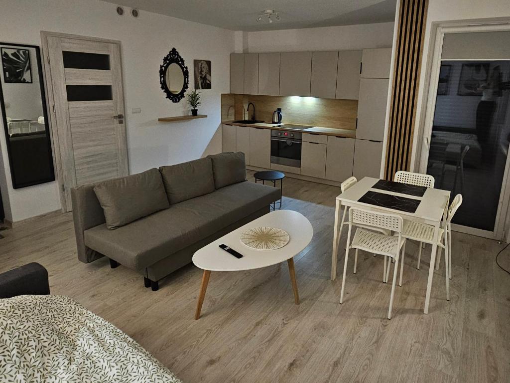 a living room with a couch and a table at Apartament Studio Centrum in Człuchów