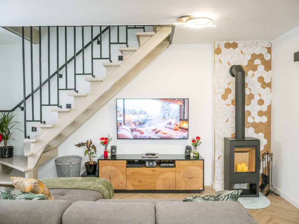 a living room with a couch and a fireplace at Vadvirág 5 by DunaVibe in Baja