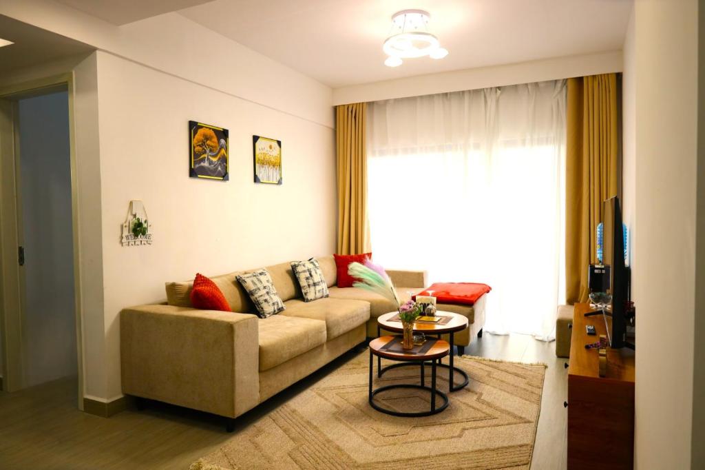 a living room with a couch and a table at GBSL Grand Villa in Nairobi