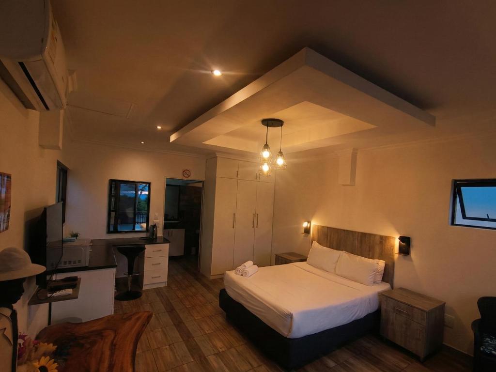 a bedroom with a white bed in a room at Van Gogh - Zur See in Ballito