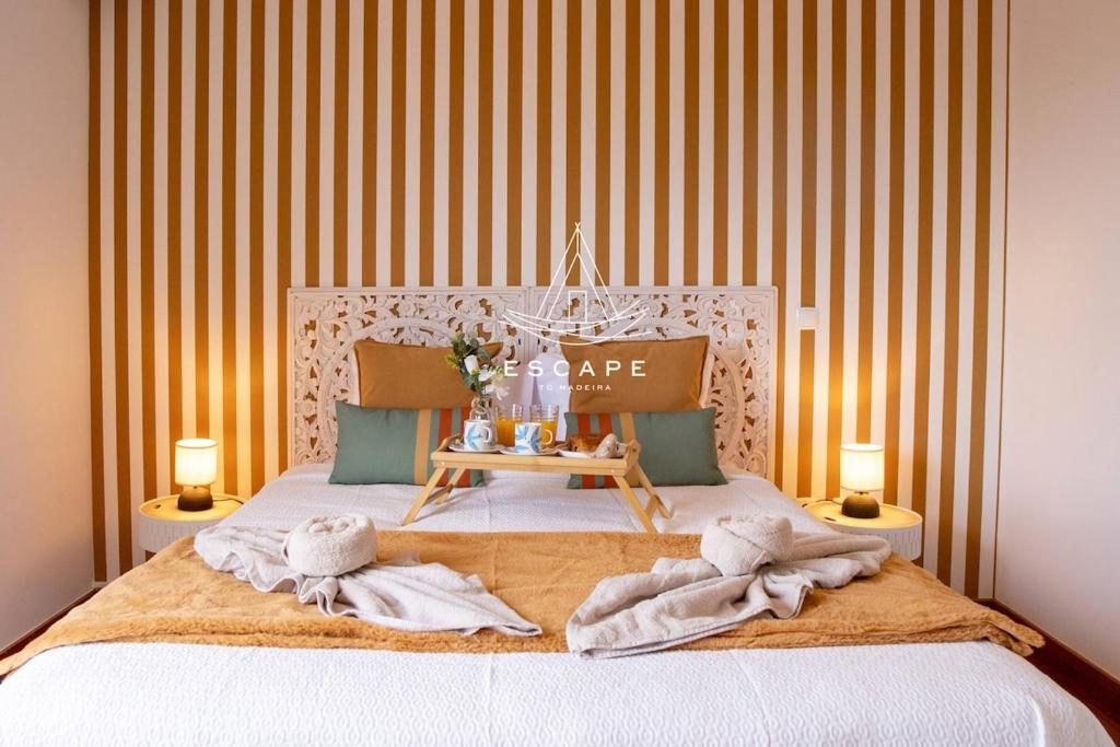 a bedroom with a bed with towels on it at Vila Sol in Prazeres